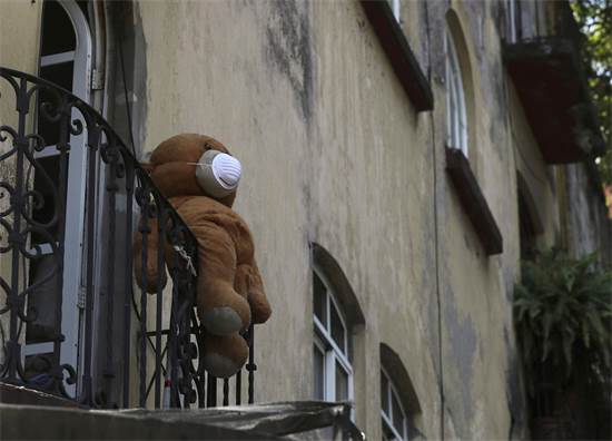 דובי חובש מסיכת פנים תלוי ממרפסת במקסיקו סיטי / צילום: AP