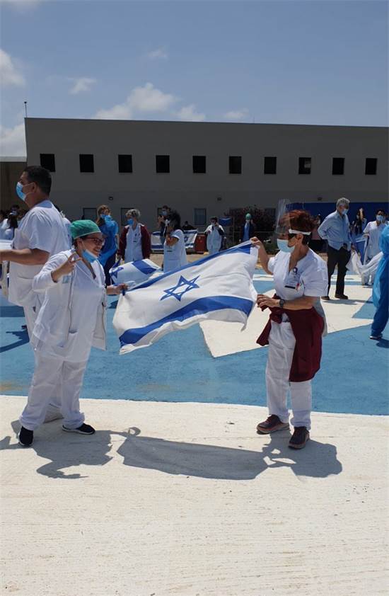 בגליל מניפים דגלי ישראל בעת שהמטס חולף מעל / צילום: דוברות משרד הבריאות, יח"צ בגליל מניפים דגלי ישראל בעת שהמטס חולף מעל / צילום: דוברות משרד הבריאות, יח"צ