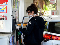 אזרחית ממלאת דלק עם כפפות בצל הקורונה / צילום: איל יצהר, גלובס