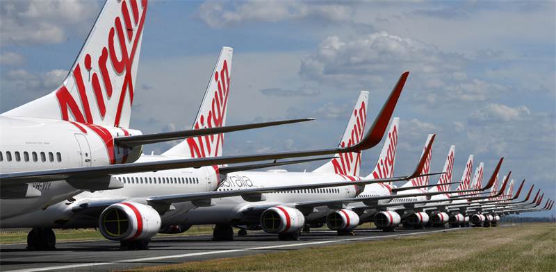 מטוסים של וירג'ין אוסטרליה חונים בנמל התעופה / צילום: Darren England/AAP Image, AP
