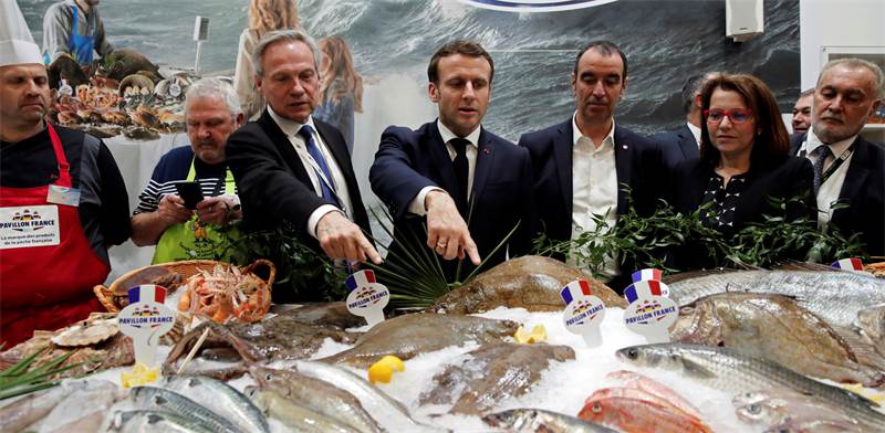 עמנואל מקרון מבקר בשוק הדגים בפריז בימים בטוחים יותר / צילום: Benoit Tessier, Associated Press